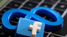 FILE PHOTO: A 3D printed Facebook's new rebrand logo Meta and Facebook logo are placed on laptop keyboard in this illustration taken on November 2, 2021. REUTERS/Dado Ruvic/Illustration